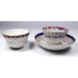 An early 19th Dresden tea bowl and saucer - decorated with puce swags and rose buds, together with