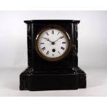A Victorian slate and green marble mantle clock - the white enamel dial set out in Roman numerals,