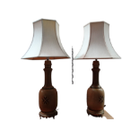 A pair of hide covered table lamps - of bottle form with gilt metal mounts, height 75cm.
