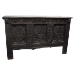 A 17th century and later oak coffer - the rectangular hinged top above a guilloche frieze and