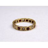 An 18ct yellow gold ruby and diamond eternity ring - size P, weight 3.1g.