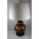 A large West German mid century pottery table lamp - of reticulated baluster form in treacle glazes,