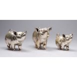 A set of three graduated silver pigs - 20th/21st century import mark, largest length 5cm, total