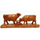 Reg PARSONS (British 20th Century) Bull, Cow and Calf - carved oak and standing on a rustic base