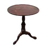 A George III and later reconstructed mahogany wine table - the circular dish moulded top above a