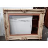 A cream painted plaster picture frame - moulded with shells, flowers and foliage, sight size 121 x