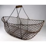 An early 20th century galvanised wire egg basket - of boat form with a turned wooden handle, width