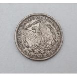 An American Morgan head one dollar coin.