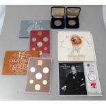 A collection of coin sets - to include the 'Celebration of Britain' Churchill £5 coin set.