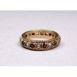 A 9ct yellow gold full hoop ruby and diamond eternity ring - size O, weight 3.6g.