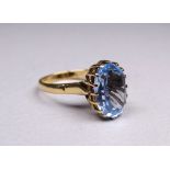 A 9ct yellow gold ring - set with an oval cut stone, possibly topaz, size P, weight 5.4g.