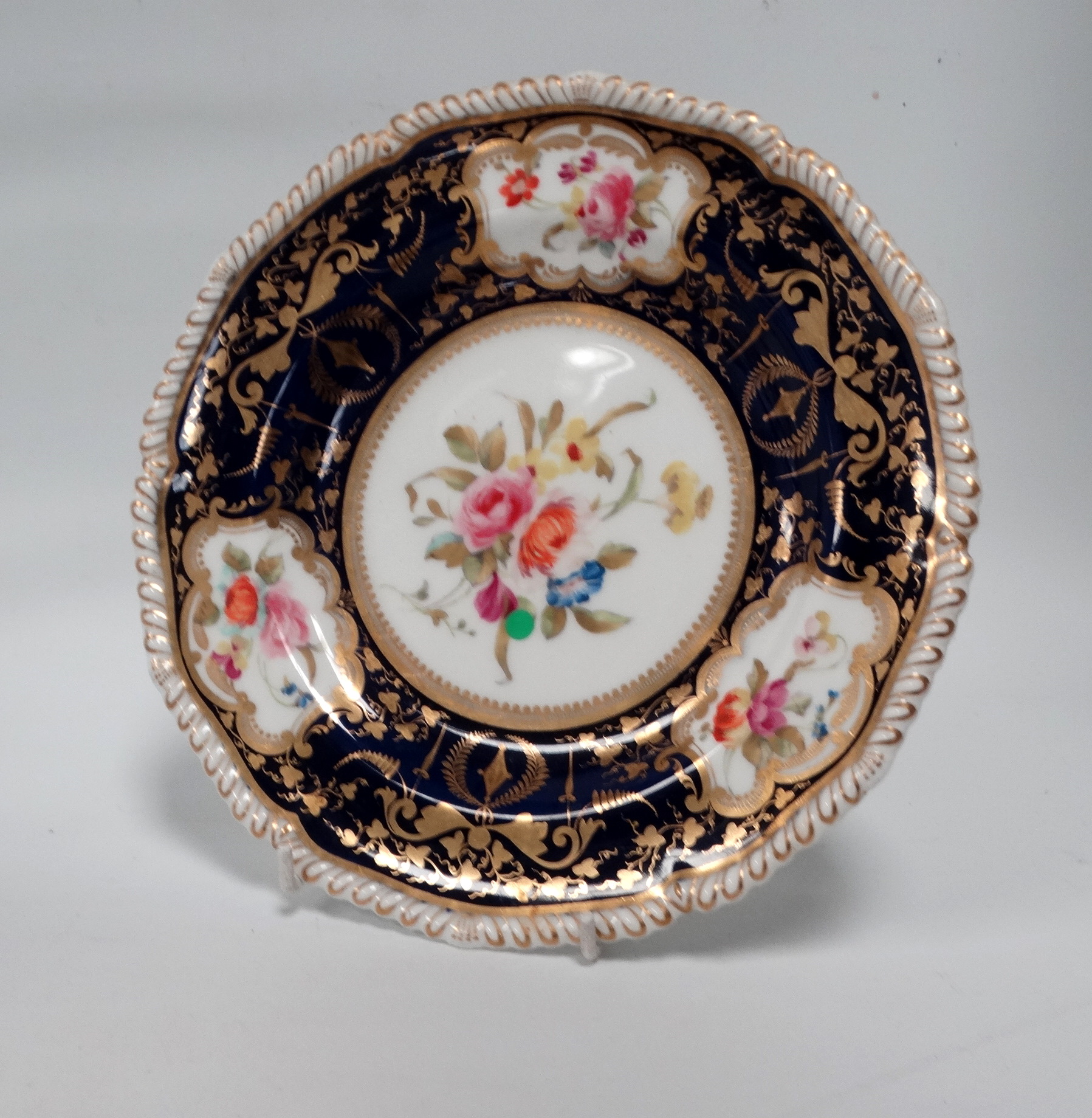 A Royal Crown Derby cabinet plate - decorated with floral vignettes on a dark blue ground with - Image 2 of 7