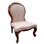 A Victorian walnut child's chair - with spoon shaped back and serpentine seat on short cabriole