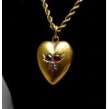 A 15ct yellow gold heart shaped pendant - set with a diamond, a ruby and a sapphire, weight 2.6g