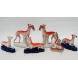 A pair of Staffordshire figures - modelled in the form of greyhounds with a rabbit, height 20cm,