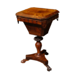 An early Victorian rosewood work table - the hinged top with canted corners enclosing a fitted