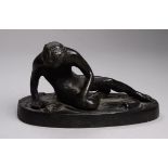 After the antique, a bronze figure of a dying gladiator - recumbent on an oval base, width 10cm.