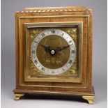 A mid 20th century walnut cased mantel clock by Elliott - the silvered chapter ring set out with