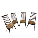 A set of four Ercol dining chairs - shaped rail backs and stick splats on contoured seats and turned