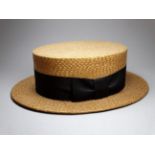 An early 20th century straw boater - with a black silk band, by Dunn & Co, size 7 1/4.