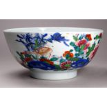 An 18th century Chinese celadon glazed famille verte decorated bowl - painted with two ducks amongst