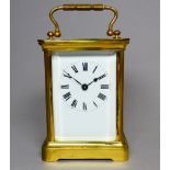 A 20th century brass carriage timepiece - with cornice case with bevelled glass plates and a white