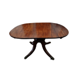 A George III and later reconstructed mahogany dining table - the oval top above a quadraform base