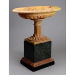 A late 19th century Sienna marble tazza - with a fluted support and raised on a green marble plinth,