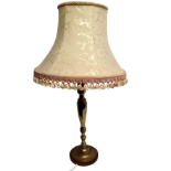 A 20th century brass table lamp - with a turned and faceted column on a circular base, height 52cm.