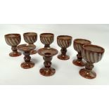 A set of six Aylesford Pottery goblets - of spiral fluted form and with a speckled brown/grey glaze,