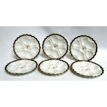 A set of six early 20th century French oyster plates - moulded with a gilt rim and ownership