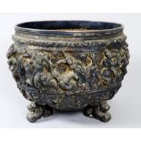 An early 20th century white metal Burmese footed pot - repoussé decorated with warriors and birds,