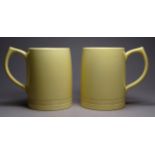 A pair of Wedgwood mugs by Keith Murray - dark cream with facsimile signature to base (2).