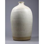 A studio pottery vase - with oatmeal glaze and narrow neck, seal mark to lower edge, height 21cm.