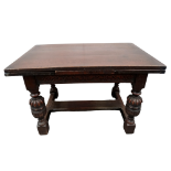 A 17th century style oak draw leaf table - the cleated top above foliate carved rails and cup and