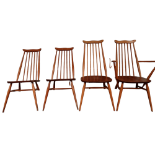 A set of four Ercol dining chairs - including one with arms, with shaped rail back and stick