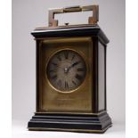 An early 20th century repeating brass carriage clock - the corniche case with bevelled