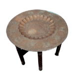 A large late 19th century circular brass Indian table - the dished top engraved with figures in a