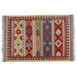 A 20th century kelim rug - multi coloured with a geometric design within a serrated sand coloured