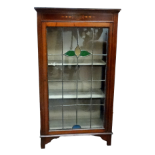 An Edwardian mahogany silver cabinet - the astragal glazed door with coloured glass, on short square