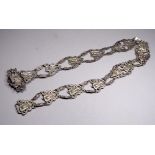 A 20th century white metal belt - of interlinked cast busts in the Art Nouveau style and clasp in