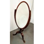 An unusual mahogany oval cheval mirror - the U-shaped support on a tripod base with cabriole legs