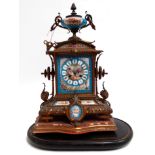 An early 20th century Sevres and gilt mounted mantle clock - an urn above panels showing country