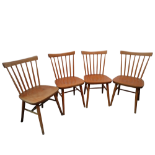 A set of four Ercol style beech dining chairs - with stickbacks and plywood contoured seats.