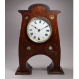An early 20th century Arts and Crafts style oak mantel clock - in the manner of Liberty, the white