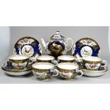 A 19th century part tea service - the bullet shaped teapot with gilt vignettes of exotic birds,