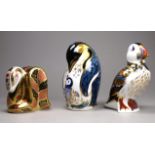 Royal Crown Derby - three paperweights, a puffin, height 12cm, a penguin with chick, height 13cm and