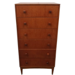 A 20th century teak six drawer chest - the graduated drawers with square knob handles and raised