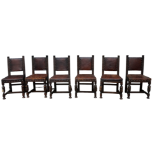 A set of six 17th century style oak dining chairs - studded leather upholstery with pad backs,
