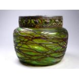 A iridescent green glass metal mounted rose bowl - with tubeline decoration, the metal collar cast